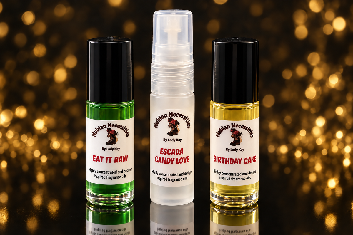 Three Nubian Necessities fragrance bottles with matching labels on a black and gold background